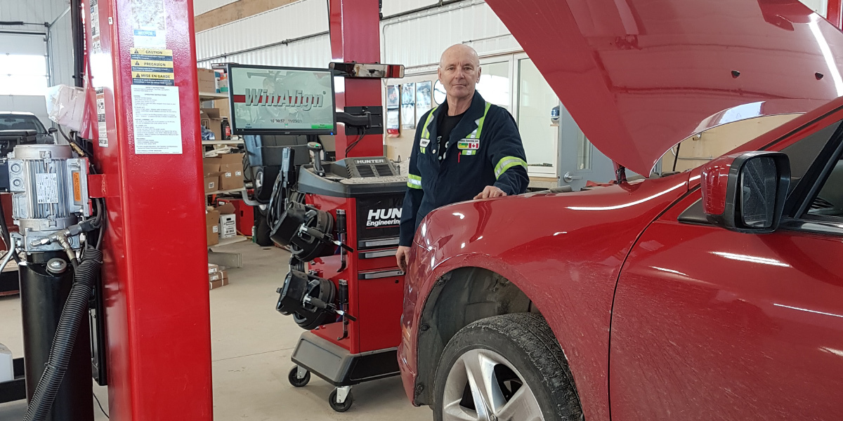 shop interior and mechanic working on vehicle